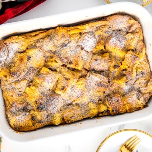 A white casserole dish containing Panettone Bread Pudding.