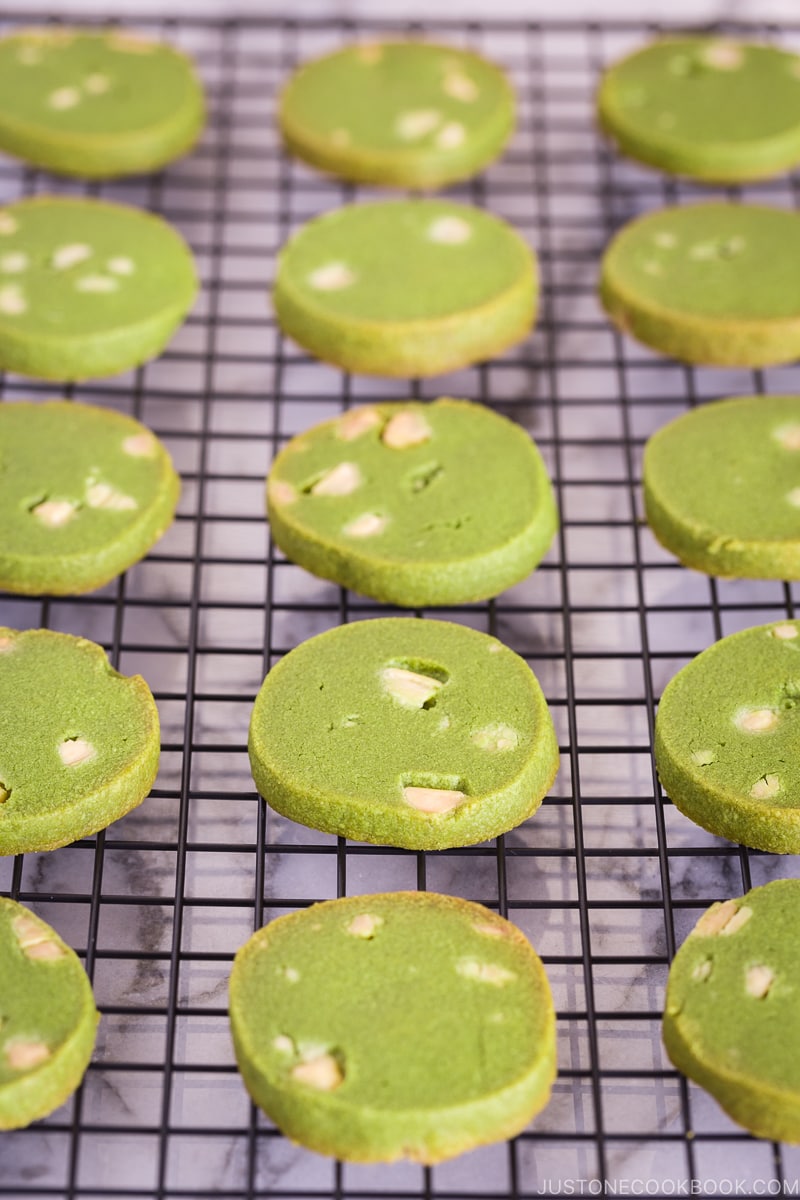 A wire rack containing matcha green tea cookies.