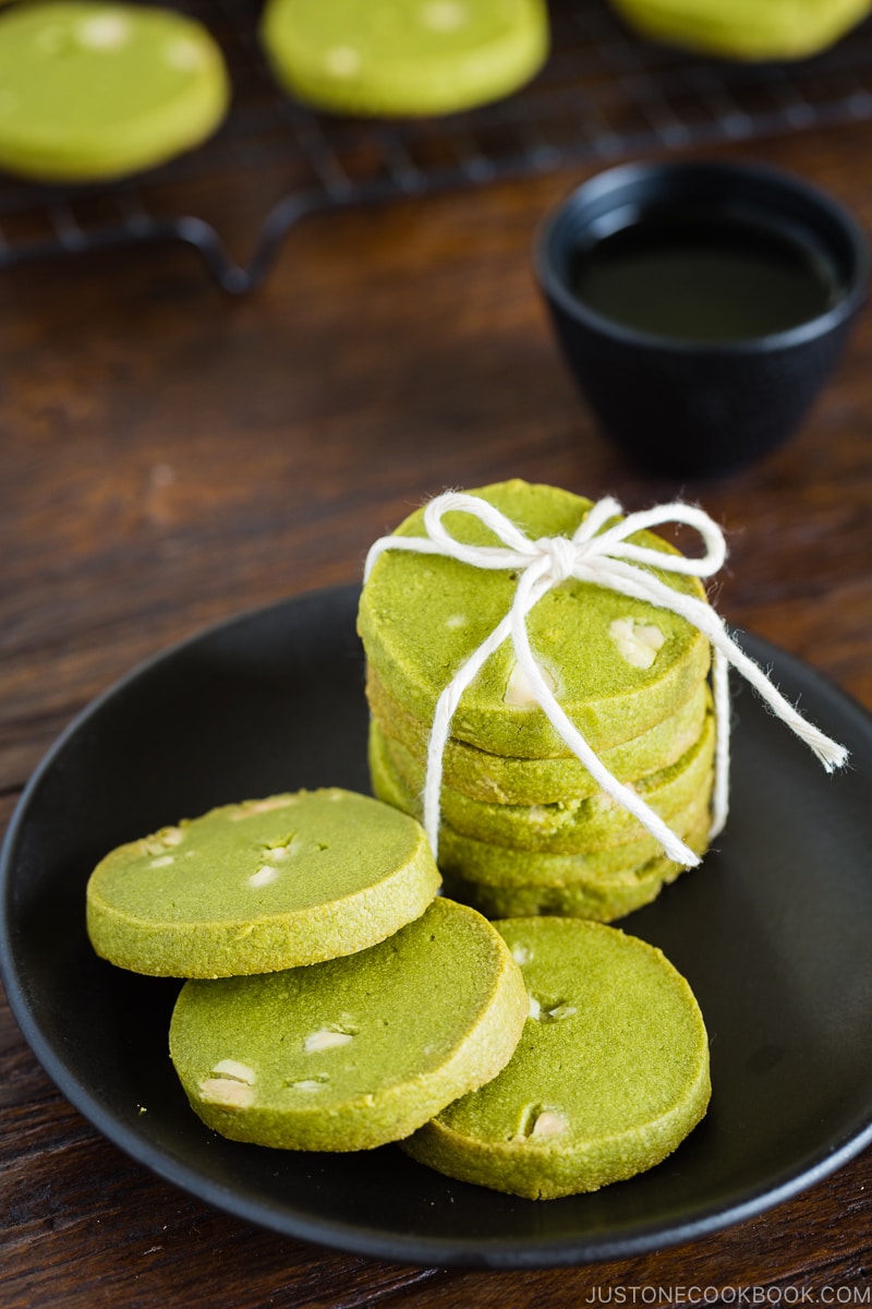 A black plate containing matcha green tea cookies.