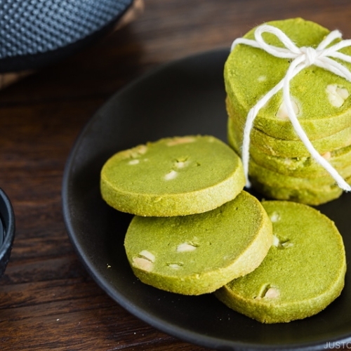 A black plate containing matcha green tea cookies.