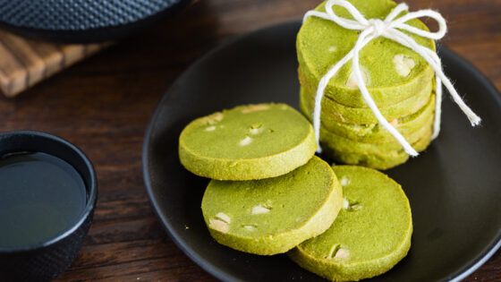 A black plate containing matcha green tea cookies.