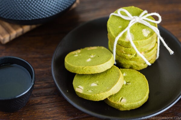 A black plate containing matcha green tea cookies.