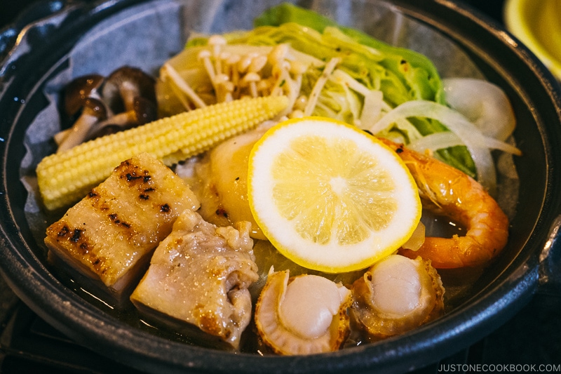 seafood, chicken, and vegetables cooked in a lemon sauce