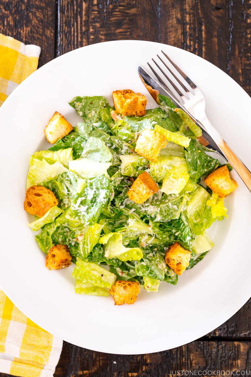 A white plate containing Caesar Salad with Homemade Croutons.