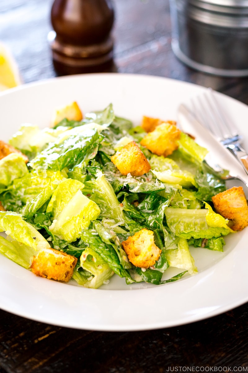 A white plate containing Caesar Salad with Homemade Croutons.