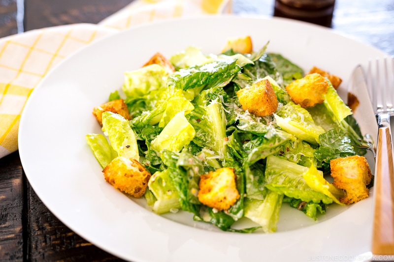 A white plate containing Caesar Salad with Homemade Croutons.