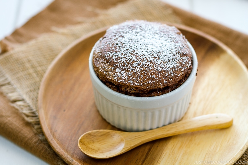 A white ramekin containing chocolate souffle.