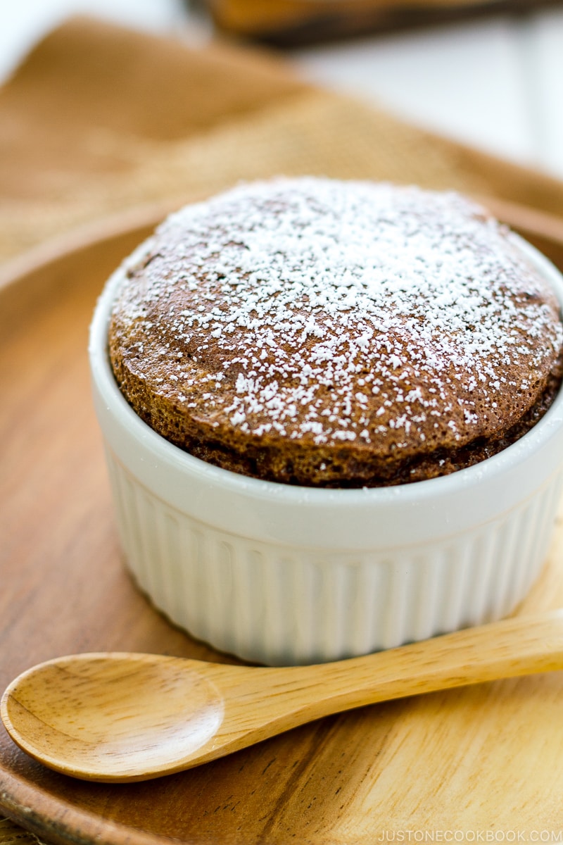 A white ramekin containing chocolate souffle.