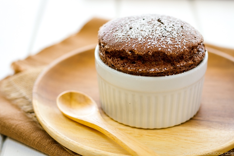 A white ramekin containing chocolate souffle.