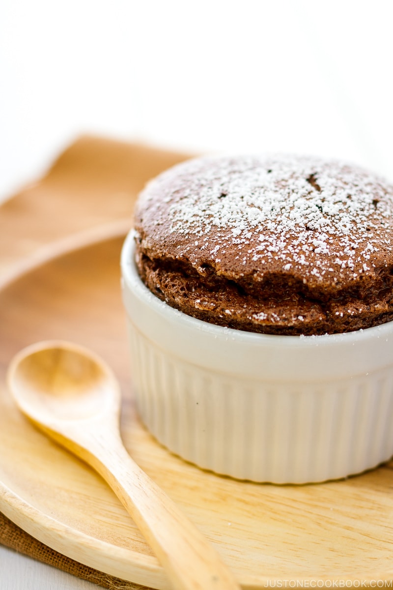 A white ramekin containing chocolate souffle.