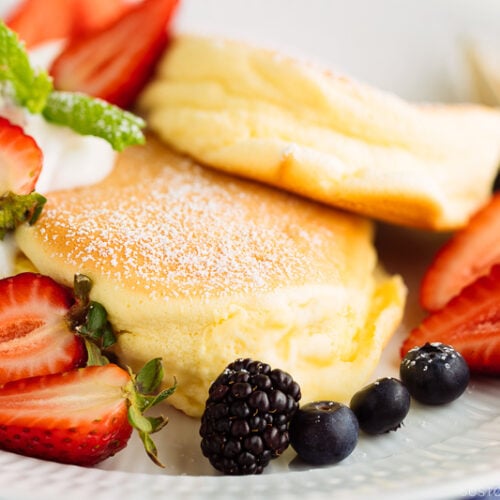 A white plate containing fluffy Japanese souffle pancakes.