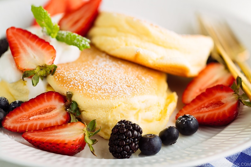 A white plate containing fluffy Japanese souffle pancakes.