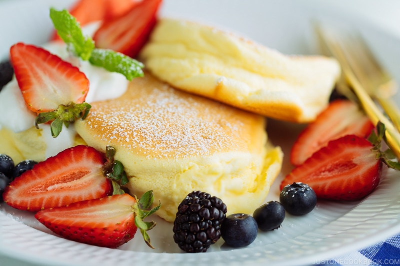 A white plate containing fluffy Japanese souffle pancakes.