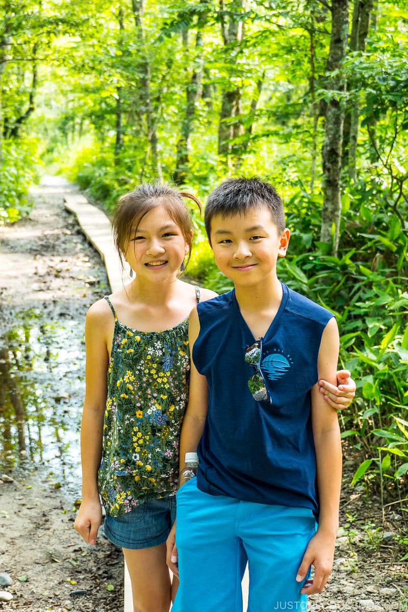 two children with trees in the background