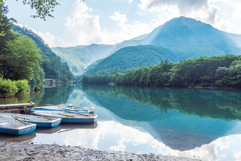 Taisho Pond with row boats and mountains in the background