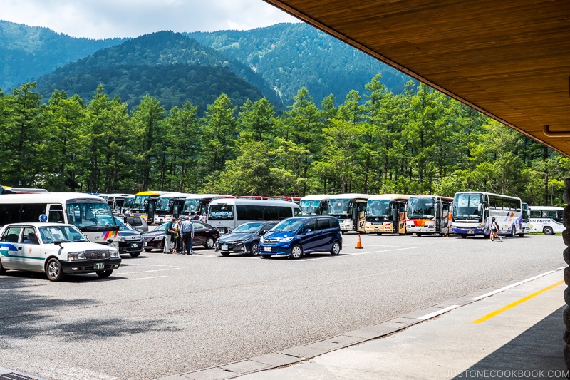 a parking lot with taxis and buses