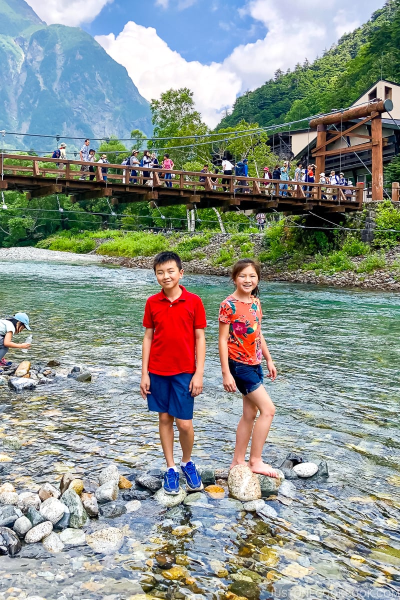 two children in Azusa River with Kappa Bridge in the background