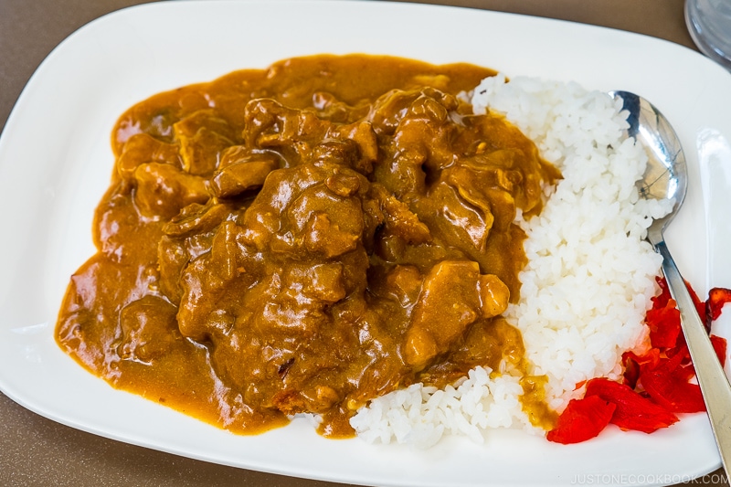 curry on rice served in a white plate