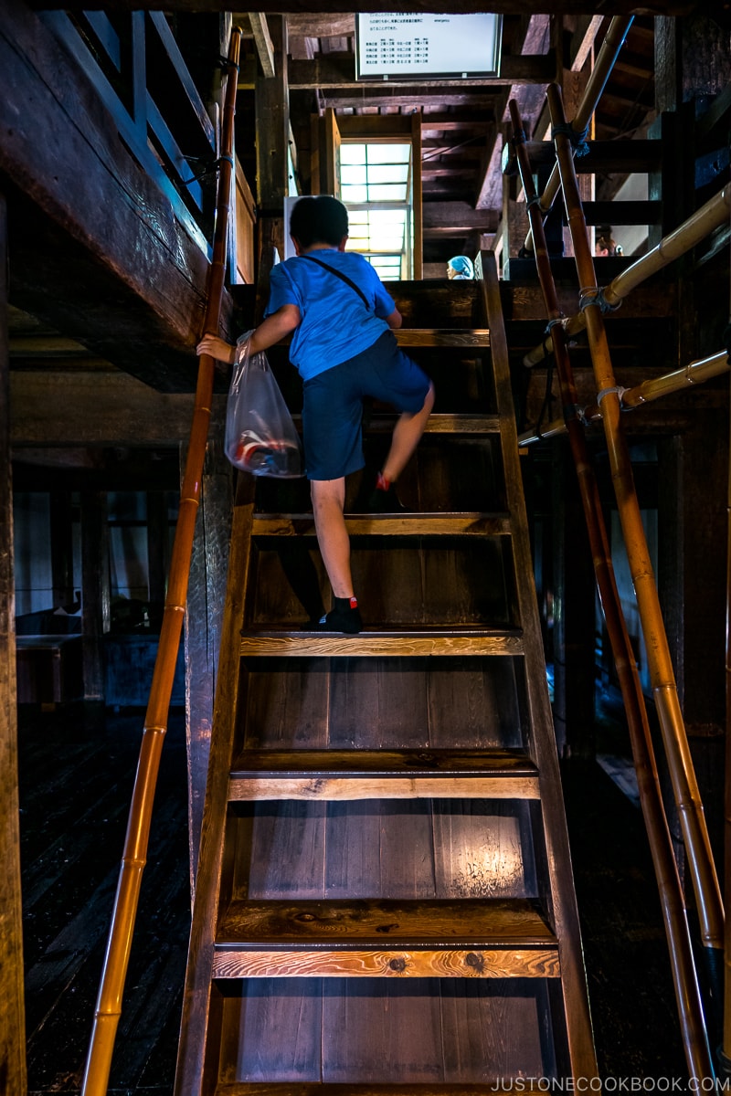 boy climbing wooden stairs