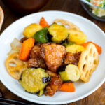 A white plate containing Ootoya’s Sweet and Sour Chicken.