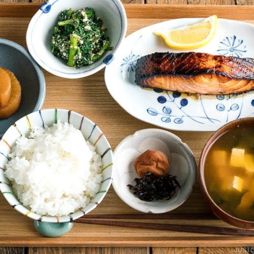 A Japanese meal set with shio koji salmon, miso soup, rice, and side dishes.