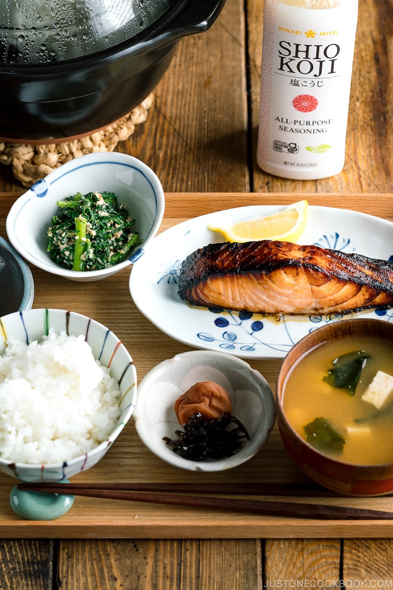 A Japanese meal set with shio koji salmon, miso soup, rice, and side dishes.