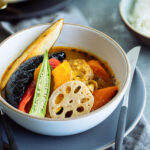 A white bowl containing sapporo soup curry.