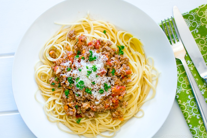 A white plate containing Spaghetti Meat Sauce.