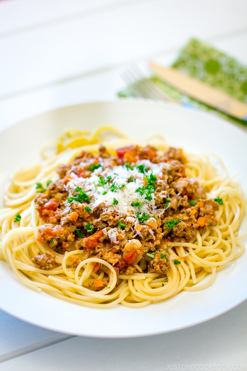 A white plate containing Spaghetti Meat Sauce.