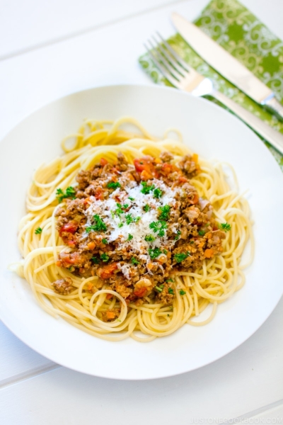 A white plate containing Spaghetti Meat Sauce.