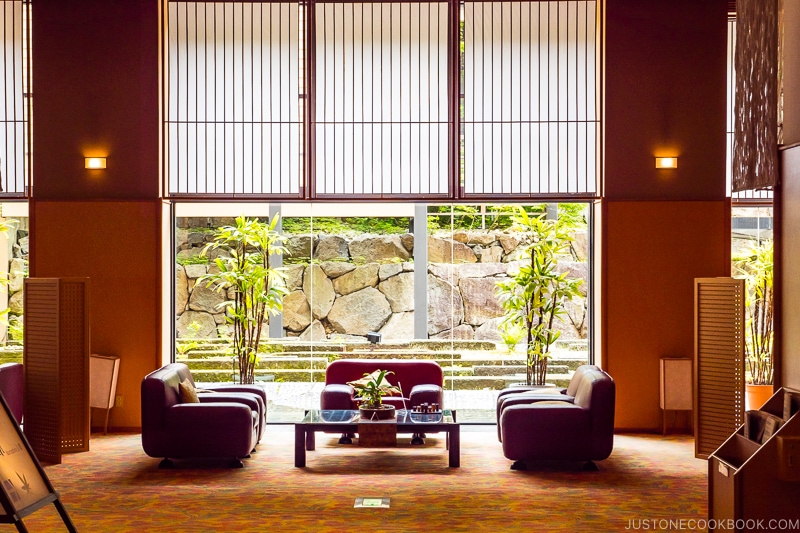 sitting area with a large window in the back on rugs