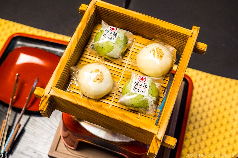 manju inside wood steamer on a metal pot on top of table