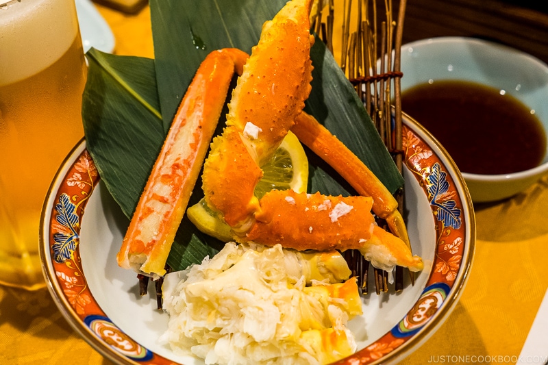 crab claw on top of bamboo leaf in a bowl