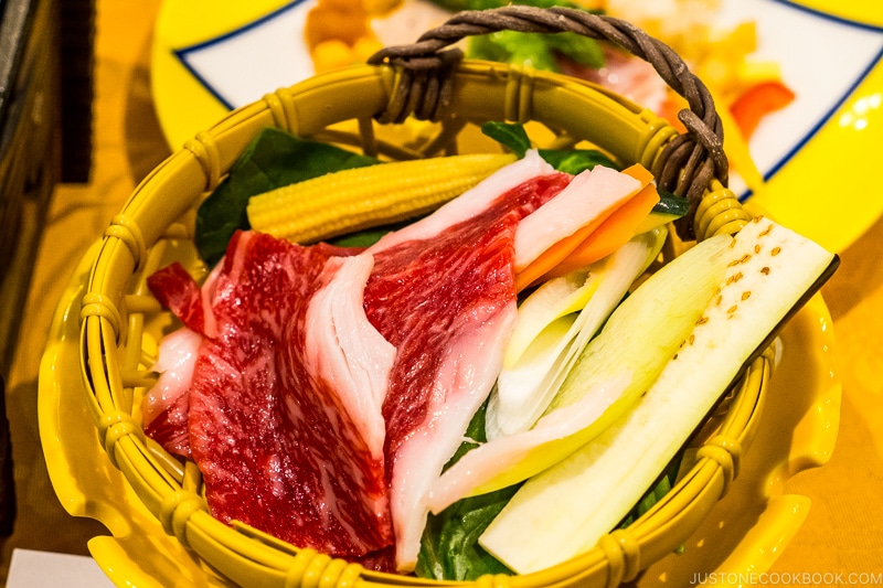 beef and negi on top of a bamboo basket