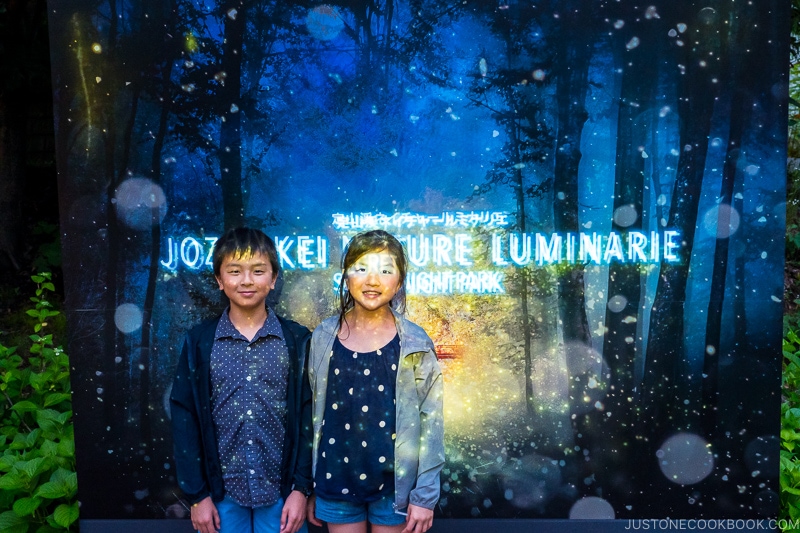 two children standing in front of Jozankei Nature Luminare sign