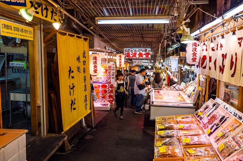 inside Otaru Sankaku Ichiba with a narrow walkway and restaurants on both side