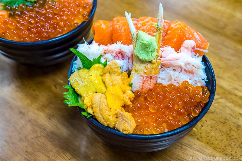 uni and seafood donburi on top of wood table