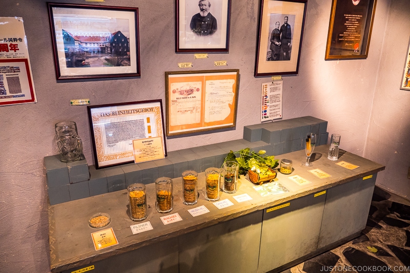 various hops on a countertop and historical framed photos on a wall