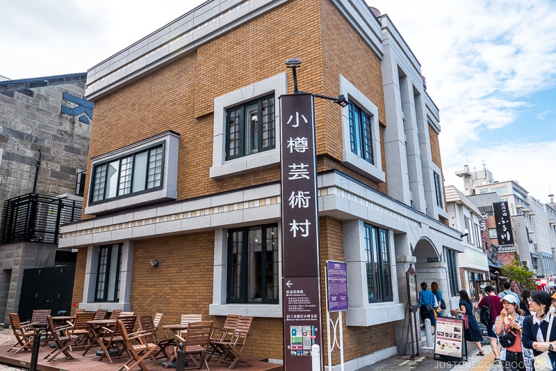 sign for Otaru Art Base next to a brick building