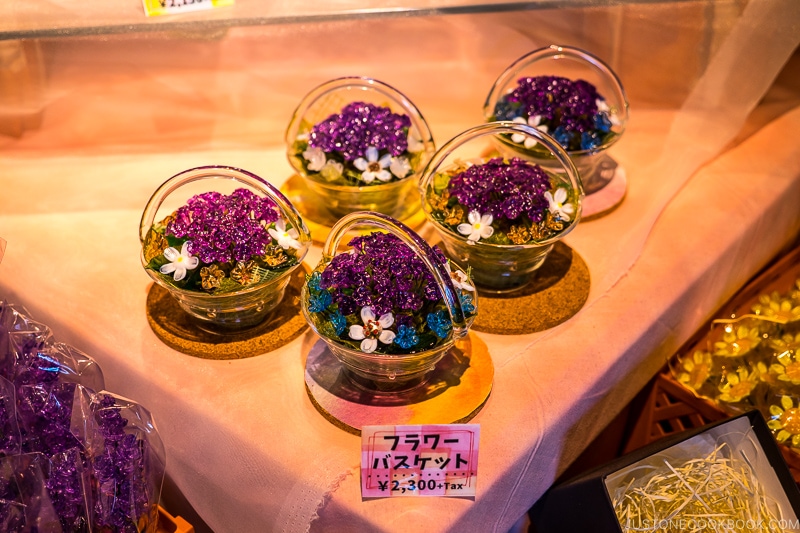 small decorative flower basket made with glass on a table