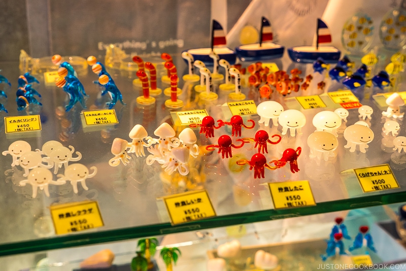 assorted creatures made from glass on a glass shelf