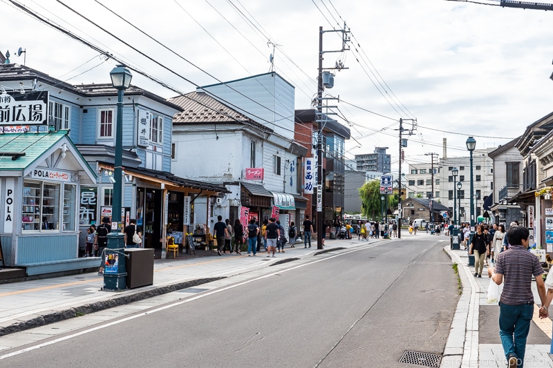 visitors walking on the sidewalks of a commercial street