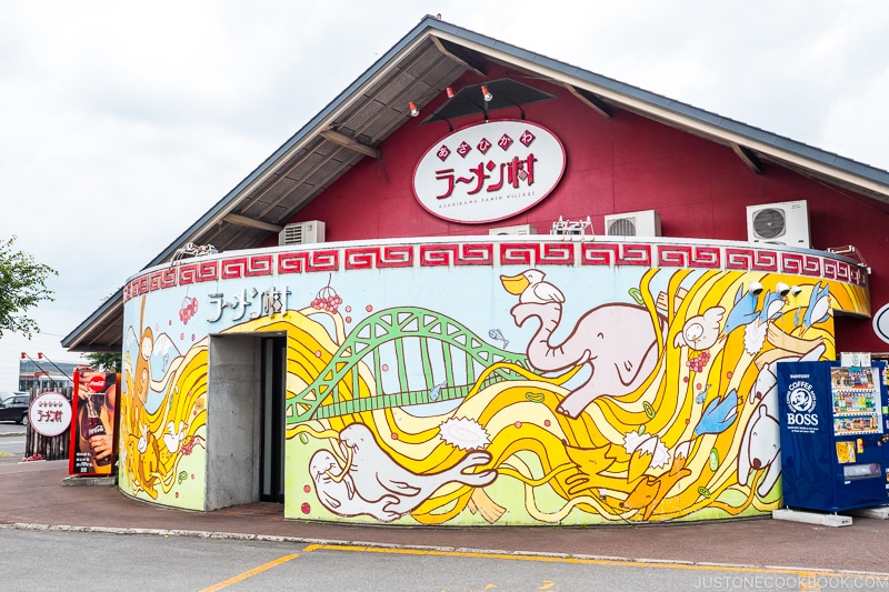 large mural on the side of the building at ramen village