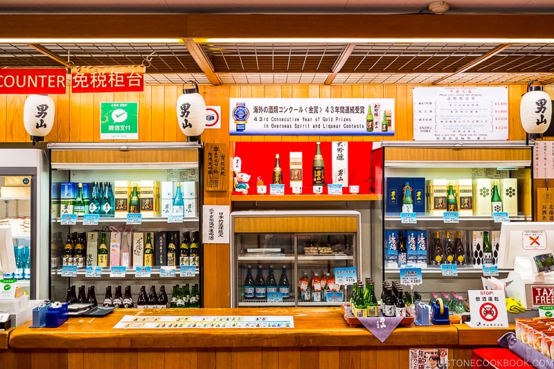 the tasting room with sake bottles along the back wall at Otokoyama Sake Brewery Museum in Asahikawa