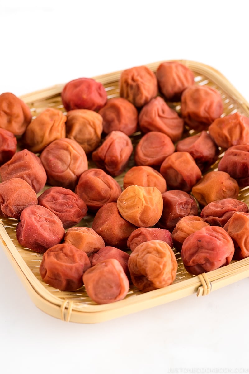 A bamboo strainer containing umeboshi (Japanese pickled plums).