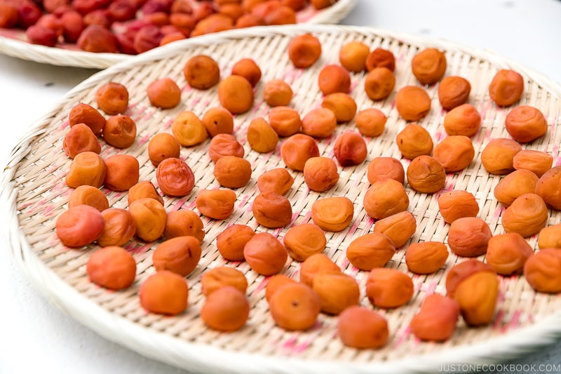 A bamboo strainer containing umeboshi (Japanese pickled plums).
