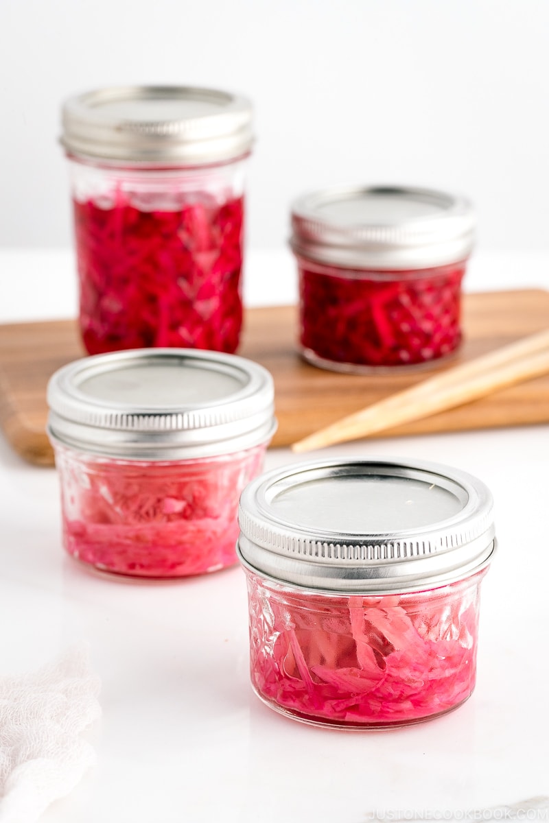 Mason jars containing beni shoga (Japanese red pickled ginger).