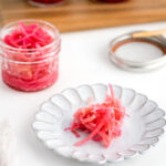 Mason jars containing beni shoga (Japanese red pickled ginger).