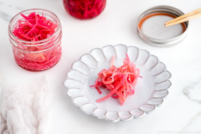 Mason jars containing beni shoga (Japanese red pickled ginger).