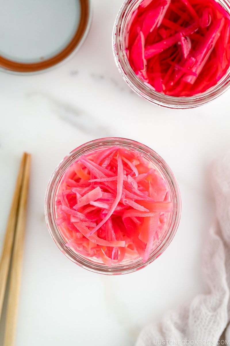 Mason jars containing beni shoga (Japanese red pickled ginger).